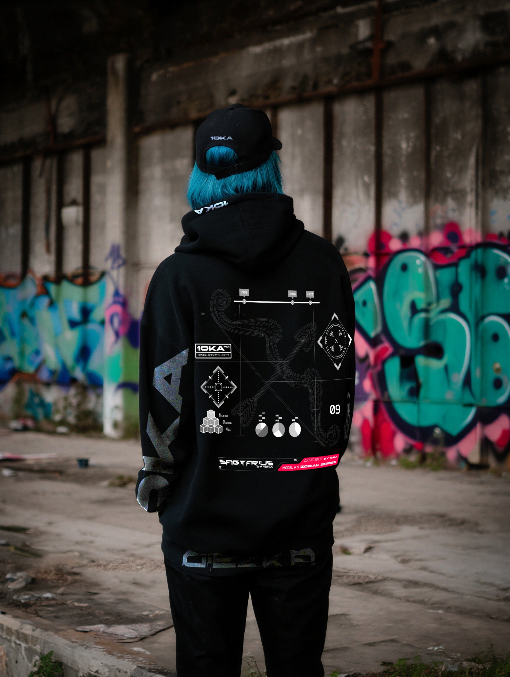 Model wearing the Zodiac Hoodie Sagittarius by 10KA in an urban setting, back view, showcasing dynamic futuristic graphics inspired by freedom and exploration.

