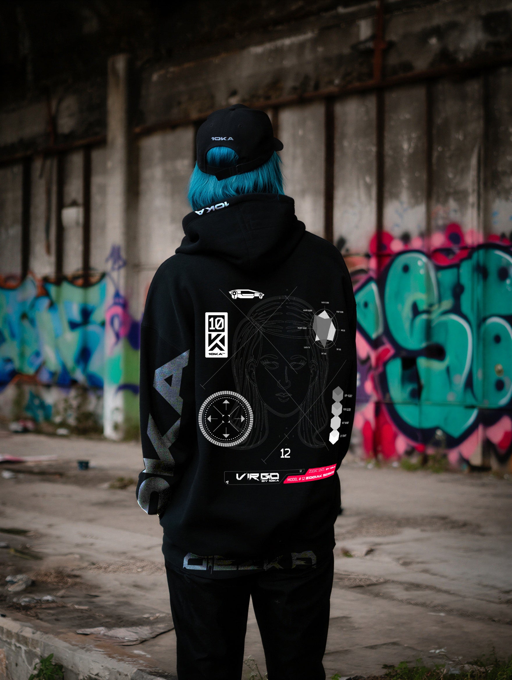 Model wearing the Zodiac Hoodie Virgo by 10KA in an urban setting, back view, showcasing minimalist futuristic graphics and Virgo earth symbolism.
